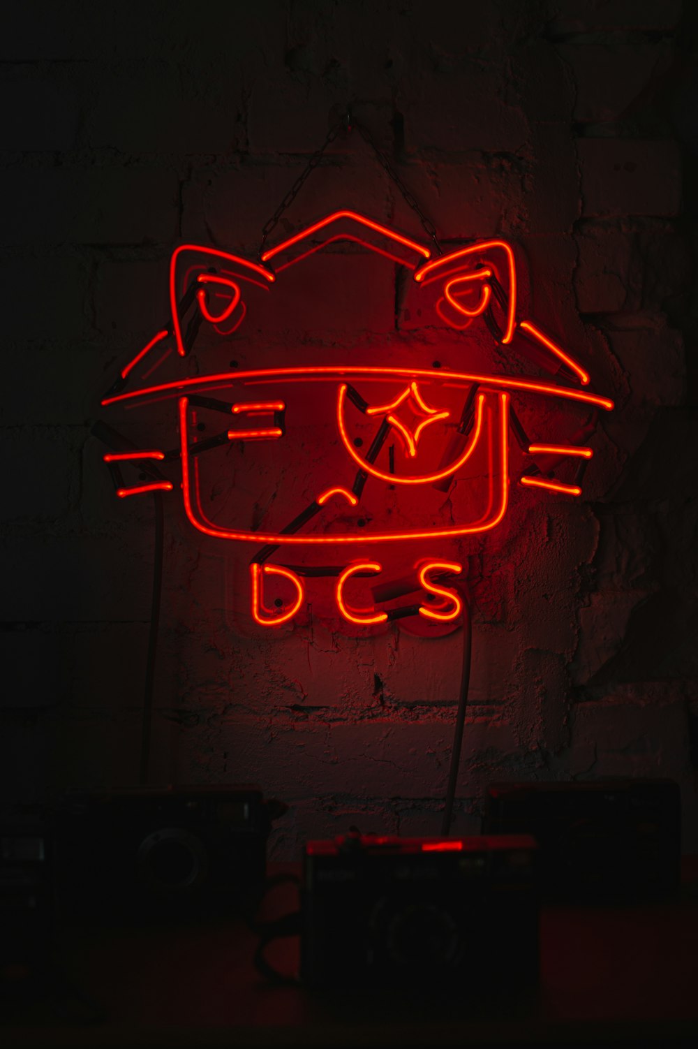 a red neon sign with a cat on it