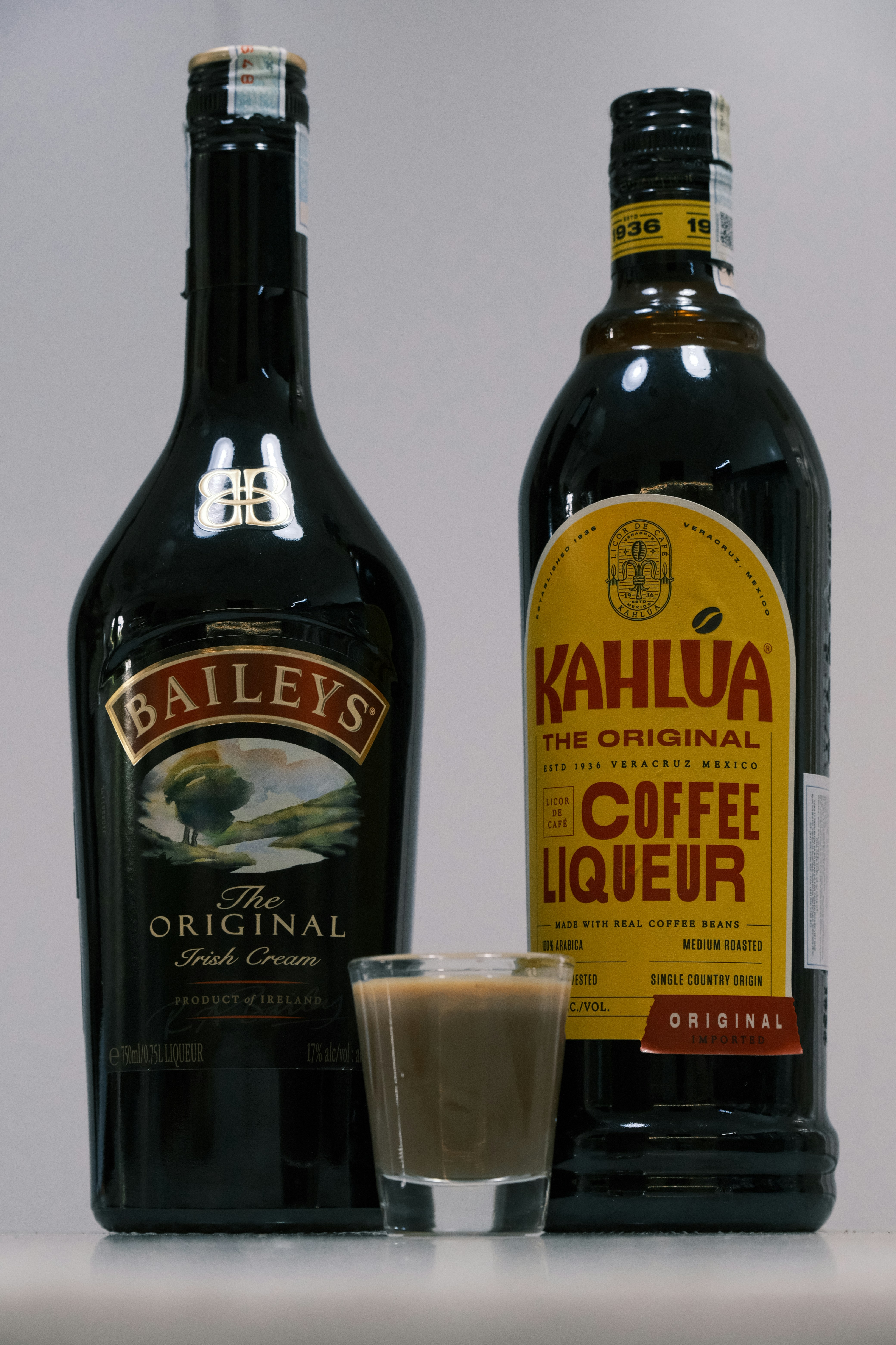 A bottle of kahlua next to a shot glass photo – Free Beer Image on Unsplash