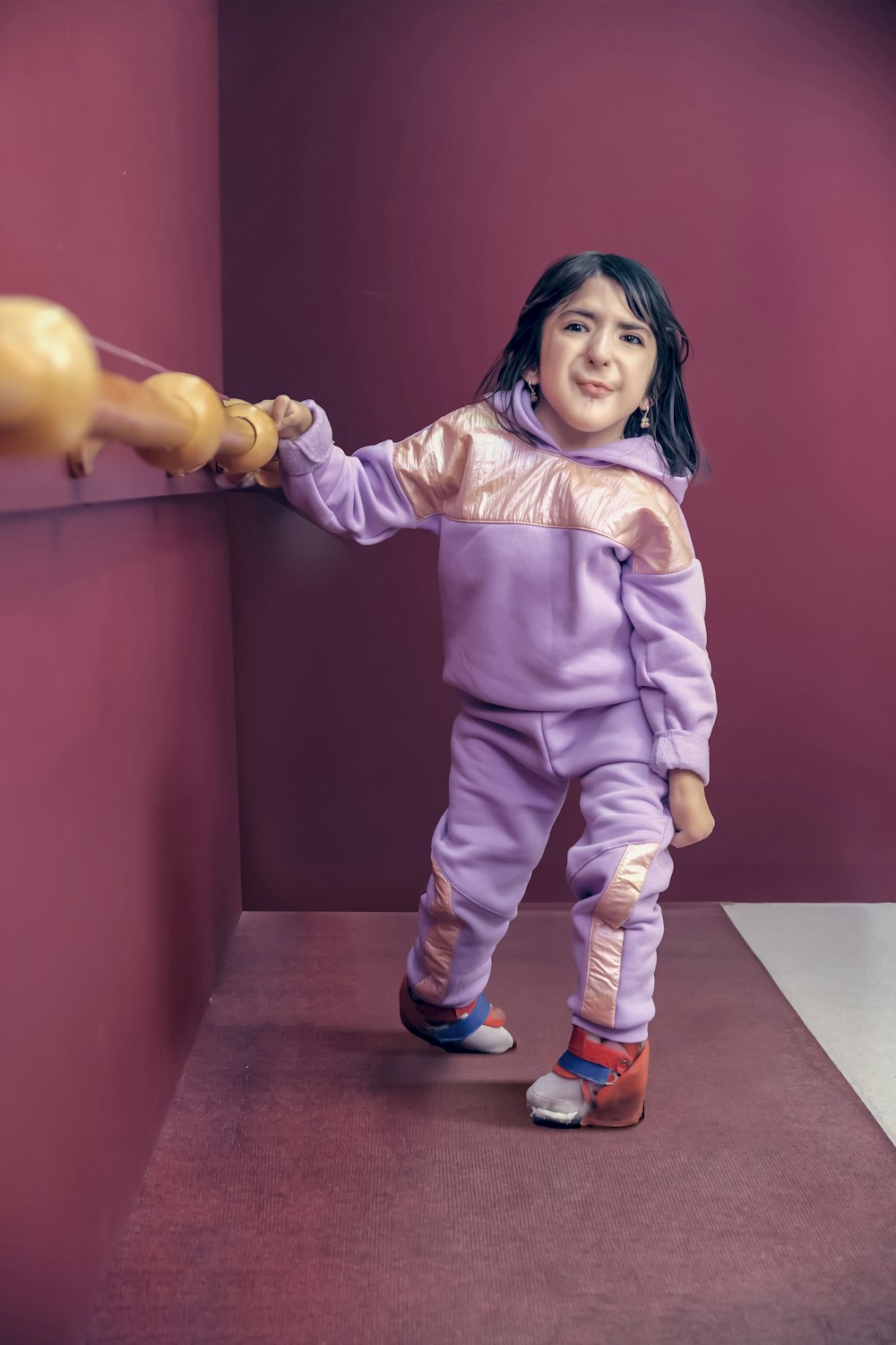 a little girl that is holding a stuffed animal