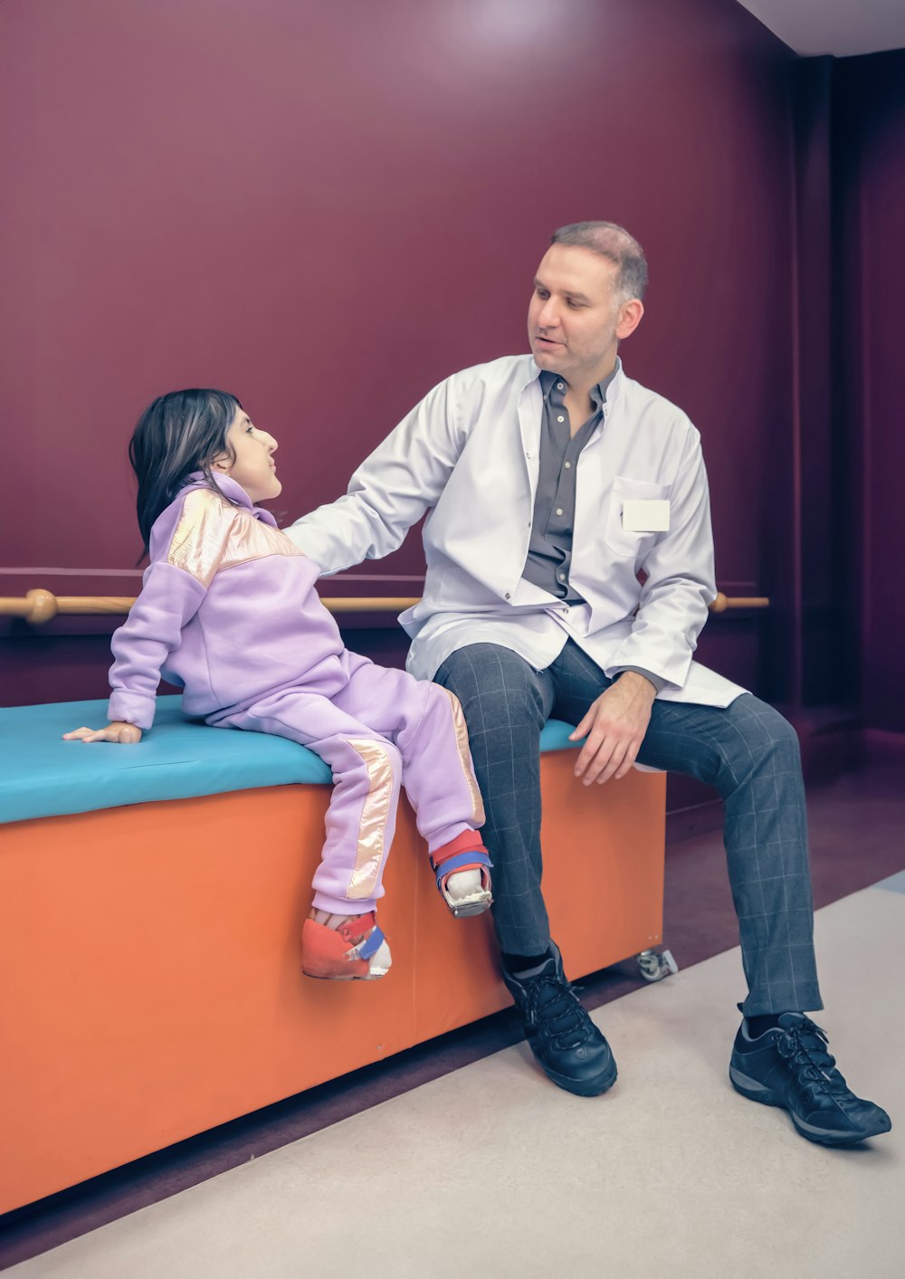 a man and a little girl sitting on a bench