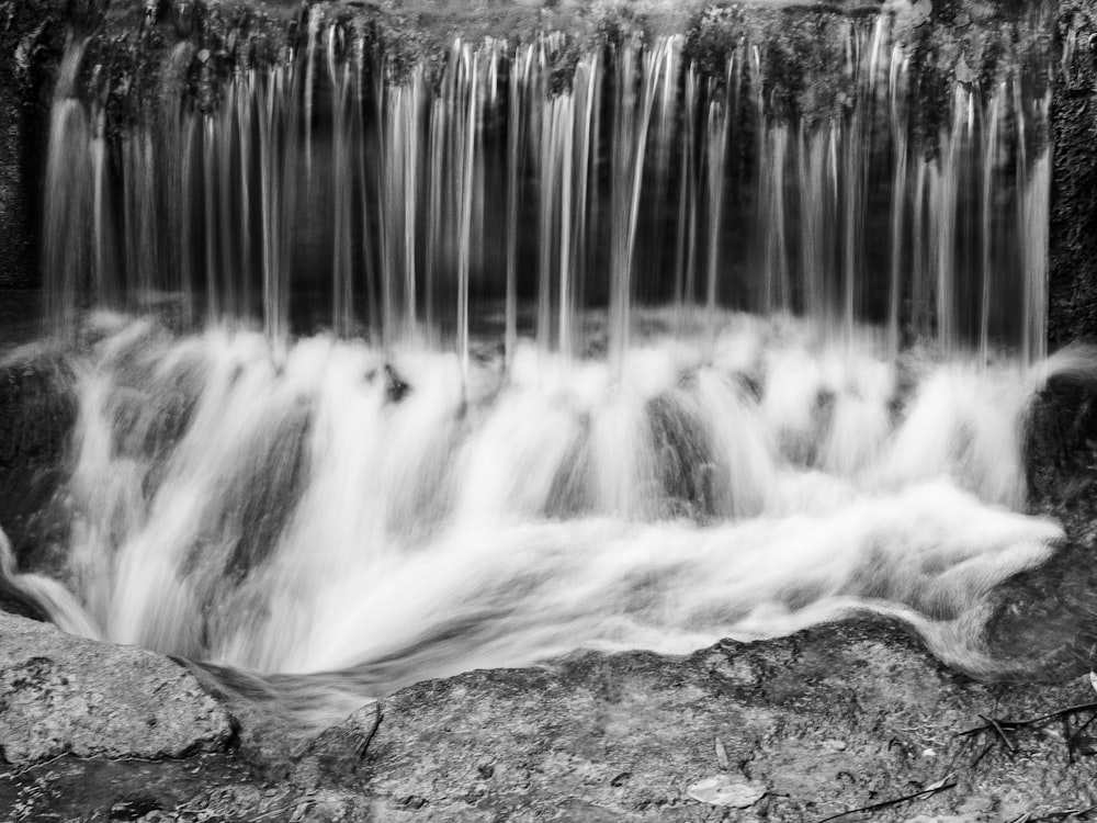 a black and white photo of a waterfall