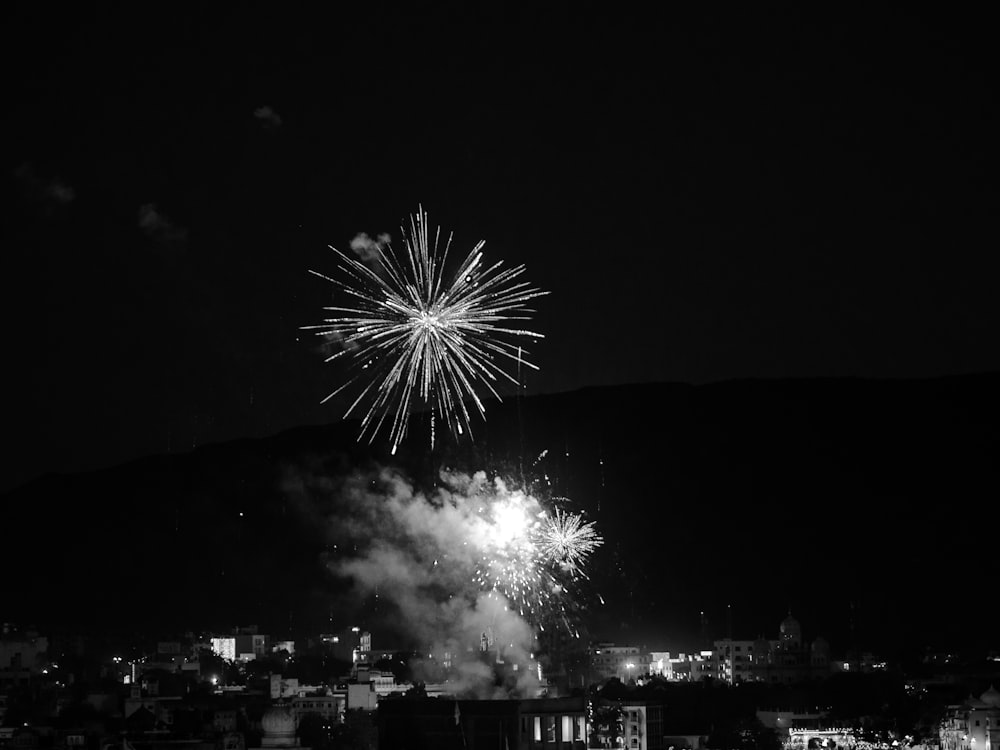 a black and white photo of a fireworks display