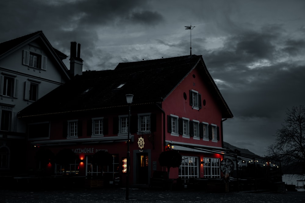 a red building with a clock on the front of it