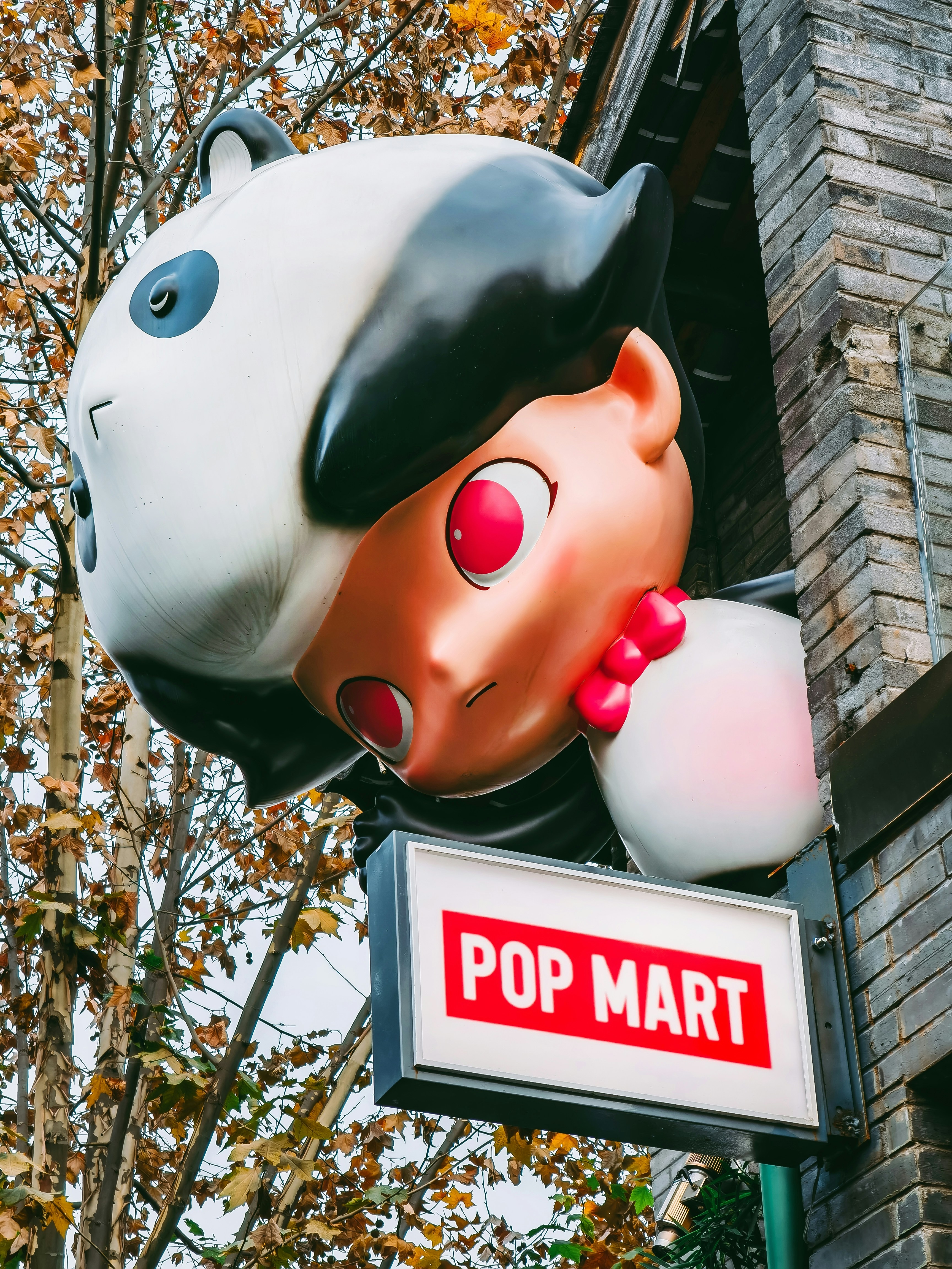 a large stuffed animal head hanging from the side of a building