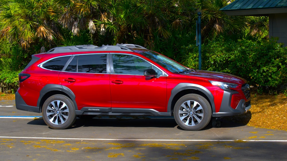 a red suv parked in a parking lot