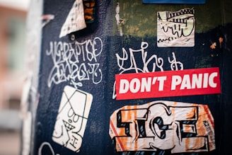a bunch of stickers that are on the side of a pole