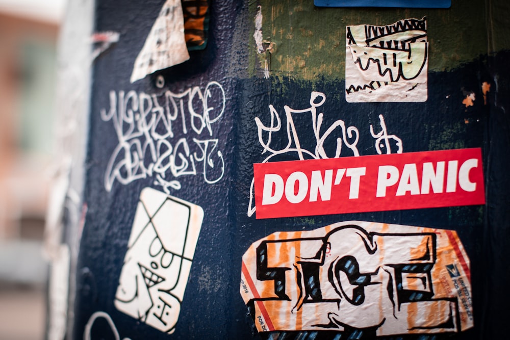 a bunch of stickers that are on the side of a pole