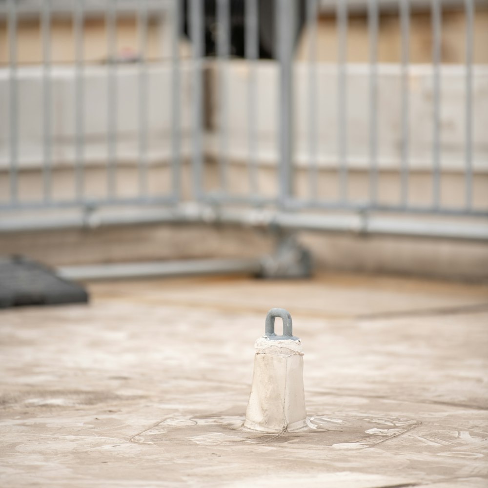 a white object sitting on top of a cement floor