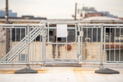 a metal gate with a sign on top of it