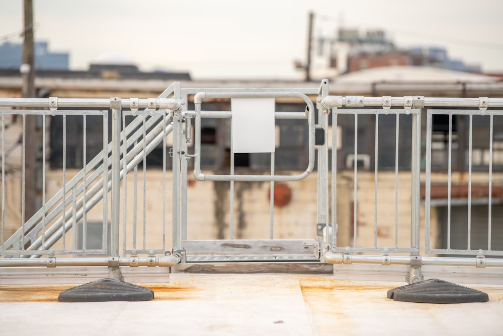 a metal gate with a sign on top of it