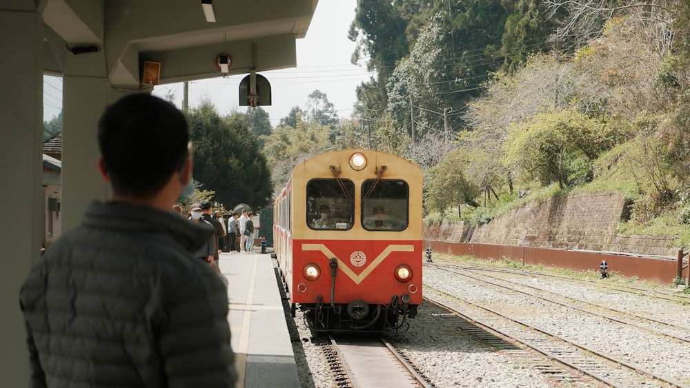 a red and yellow train traveling down train tracks