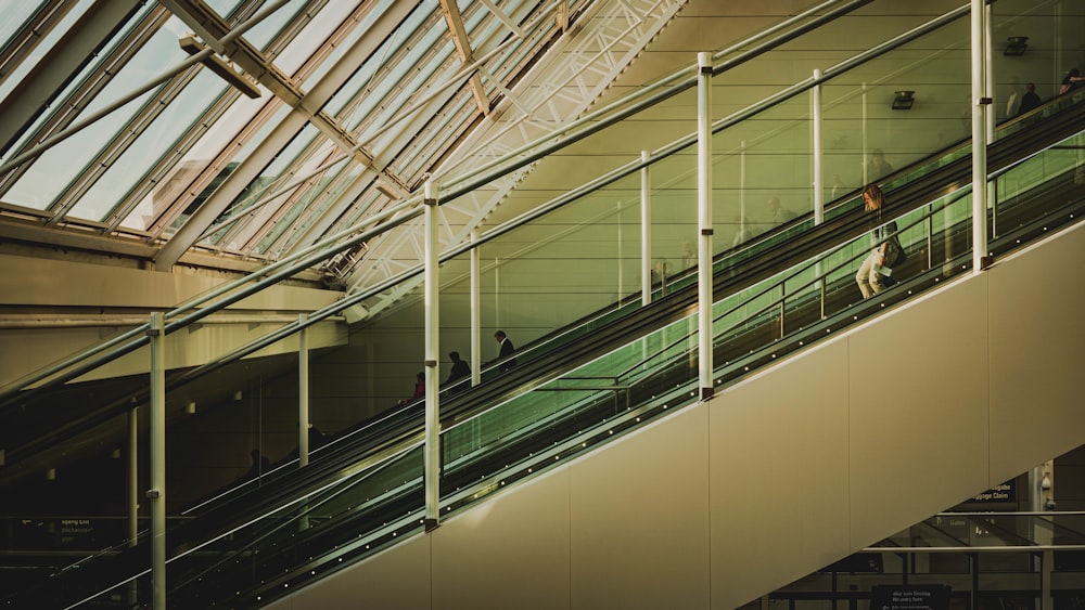 an escalator in a building with people walking up and down it