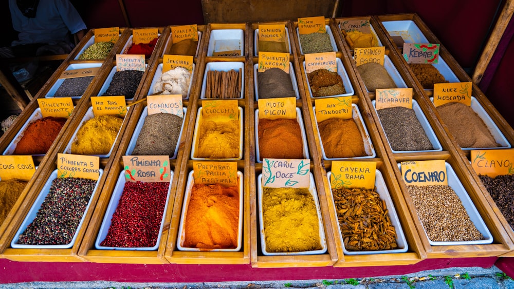 a variety of spices on display in wooden trays