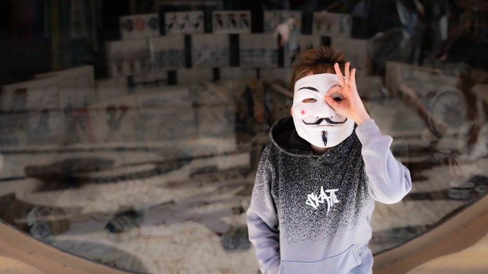 a young boy wearing a mask covering his face