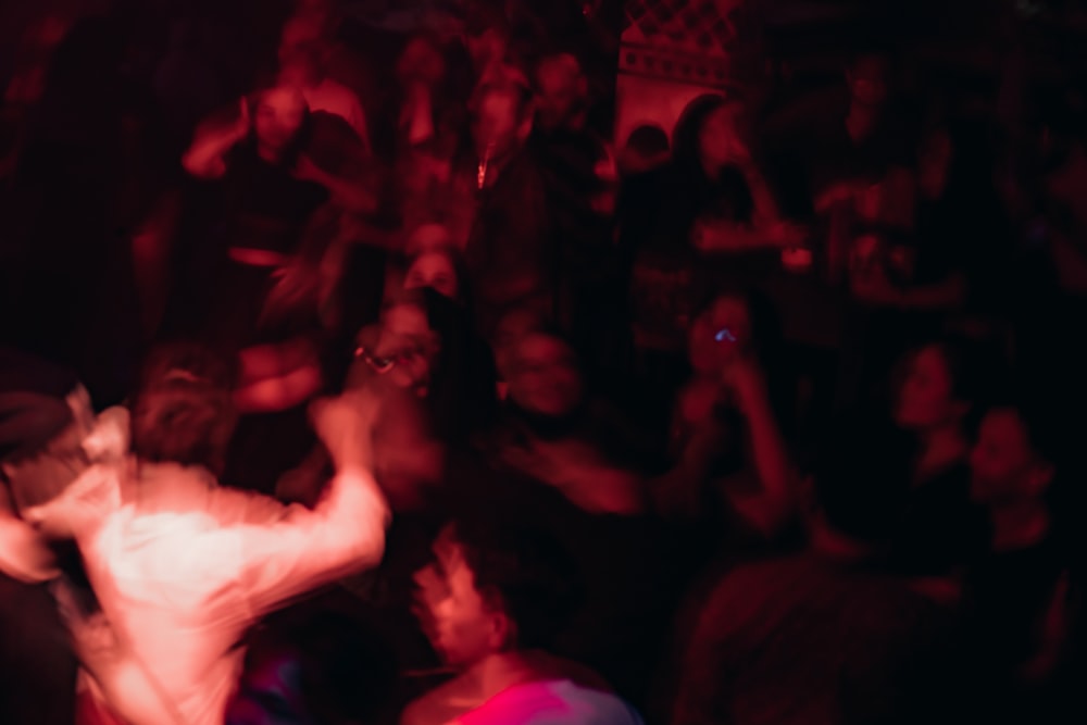 a blurry photo of a man dancing in a club