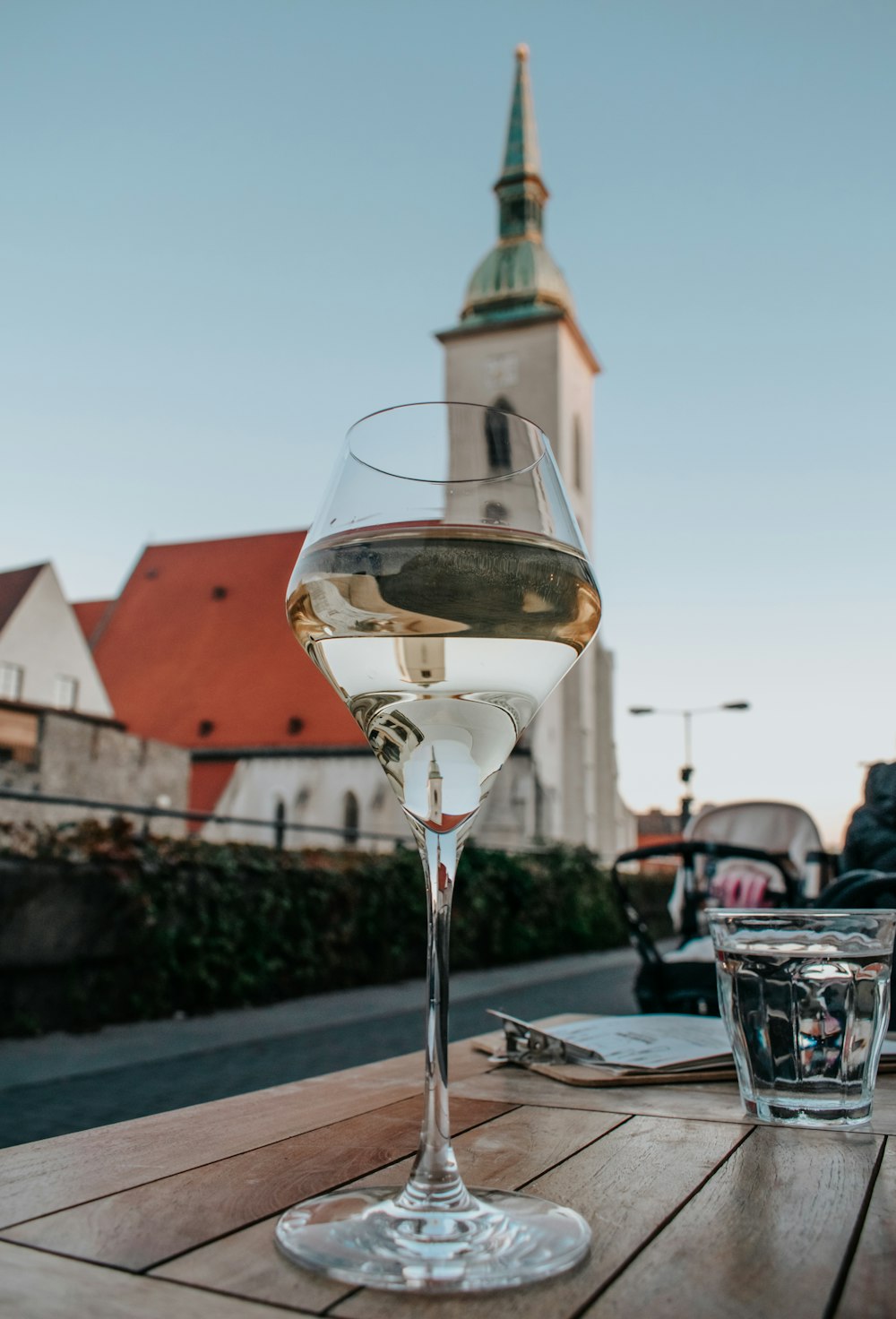 a glass of wine sitting on top of a wooden table