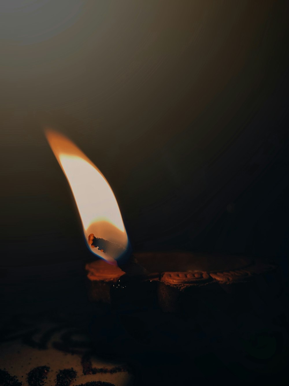 a candle that is burning in the dark