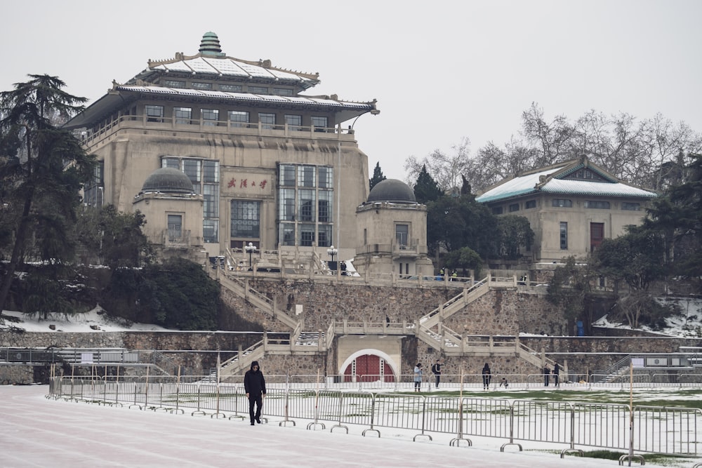 a person standing in front of a large building