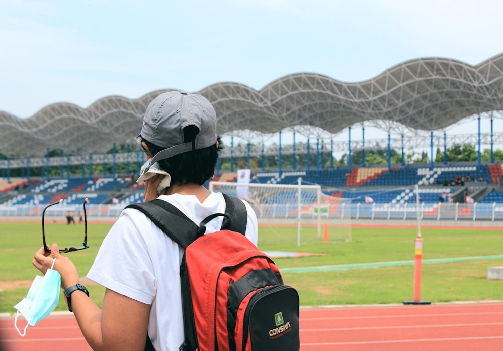 a person with a backpack and a tennis racket