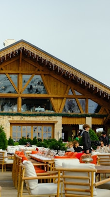 a group of people sitting at tables in front of a building