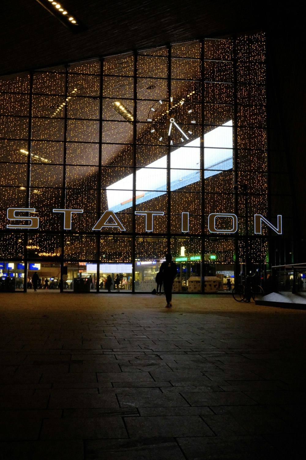 a person standing in front of a large building