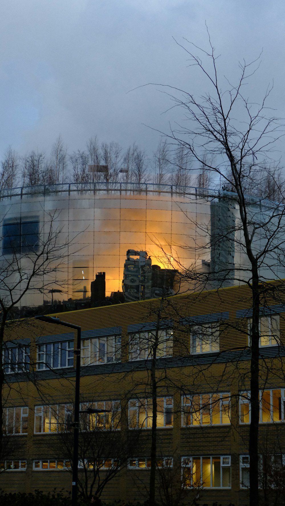 a building with a reflection of the sky in the windows