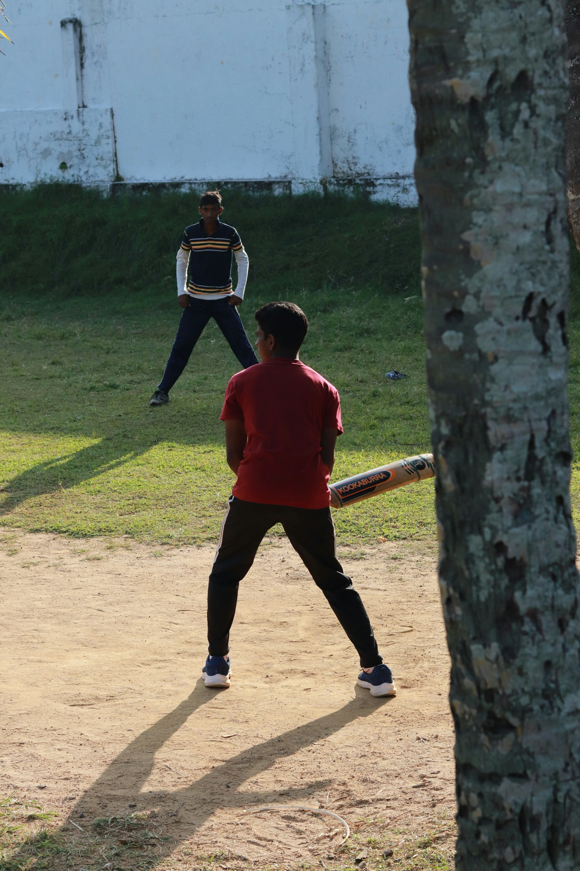 A man holding a baseball bat on top of a field
