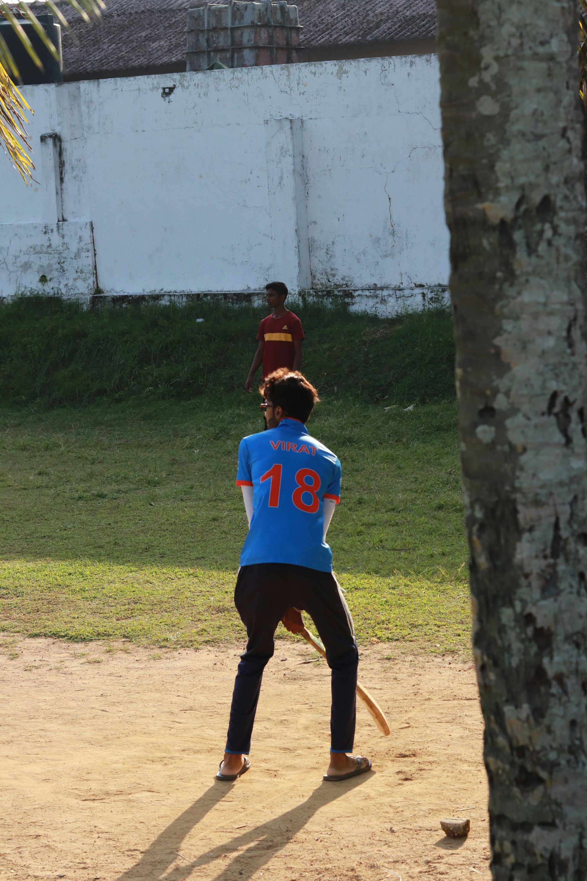 a man holding a baseball bat on top of a field