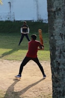a man holding a baseball bat on top of a field