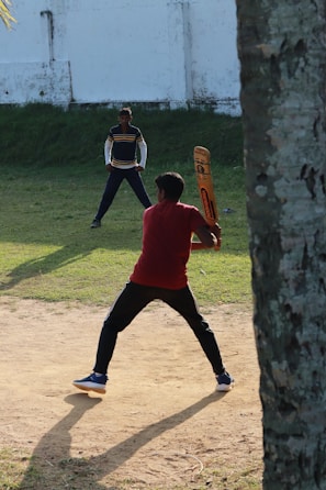 a man holding a baseball bat on top of a field
