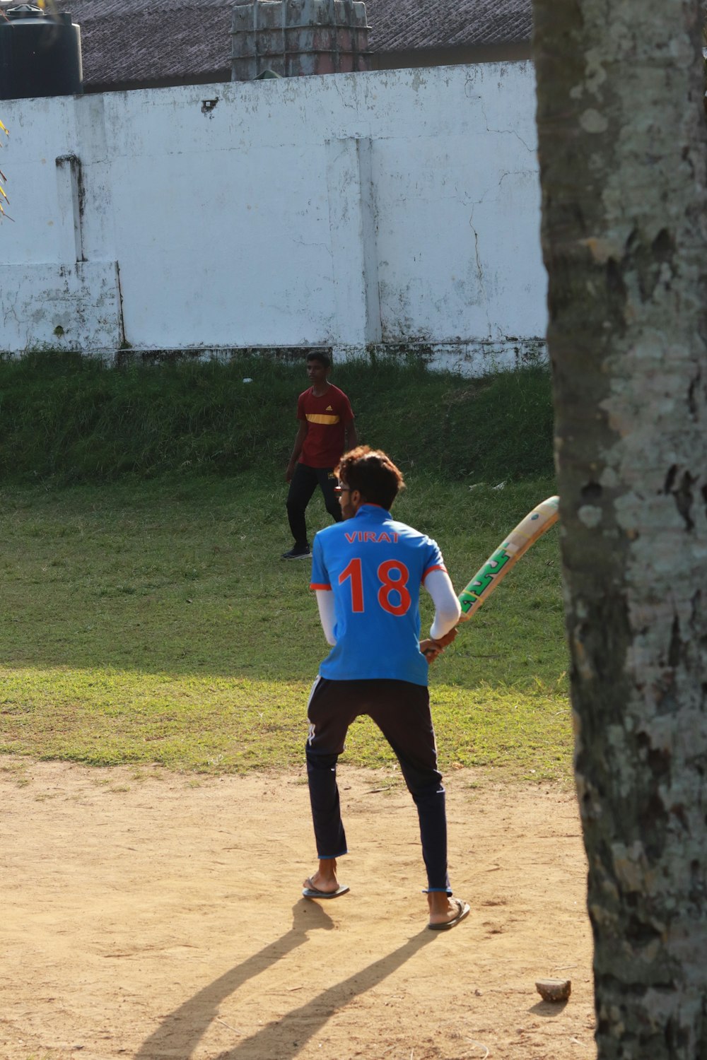 a person holding a baseball bat on a field