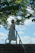 a woman in a white dress and hat walking up a set of stairs