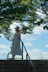 a woman in a white dress and hat walking up a set of stairs