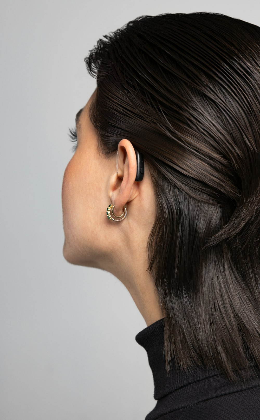 a woman wearing a pair of earrings on her ear