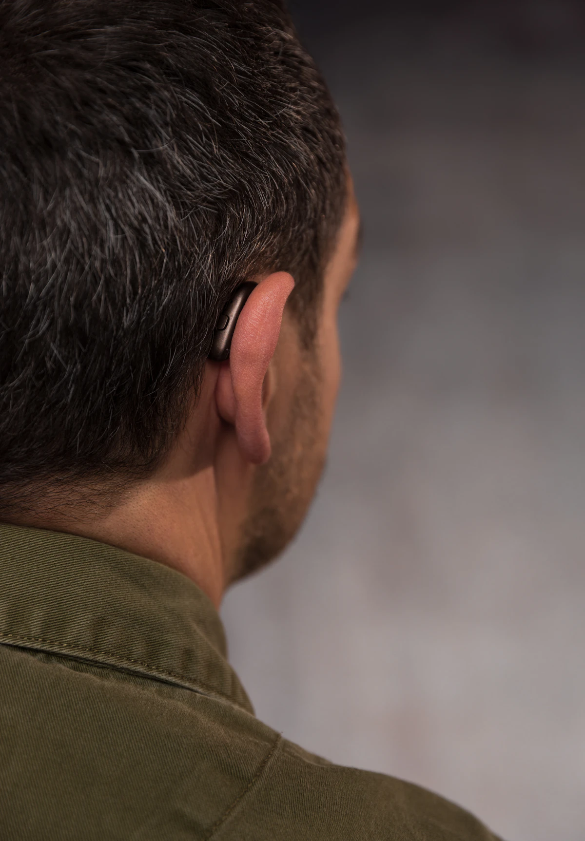 A man wearing a modern hearing device