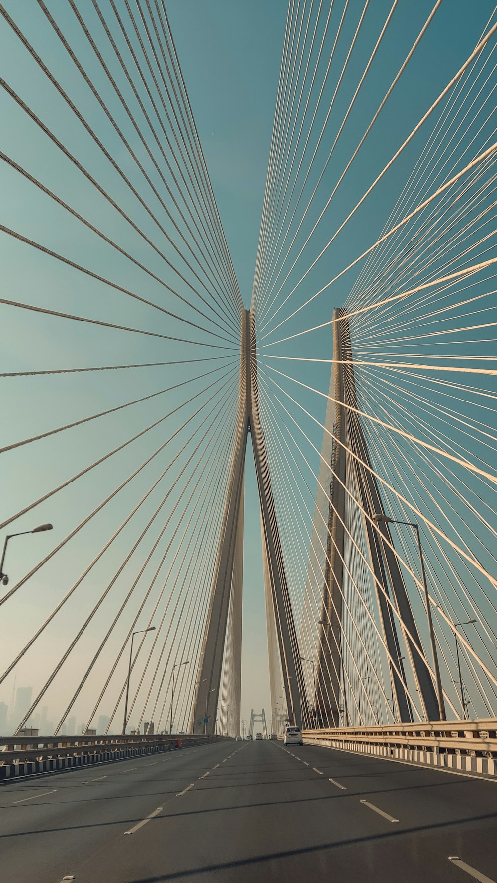 a view of a very tall bridge from a car