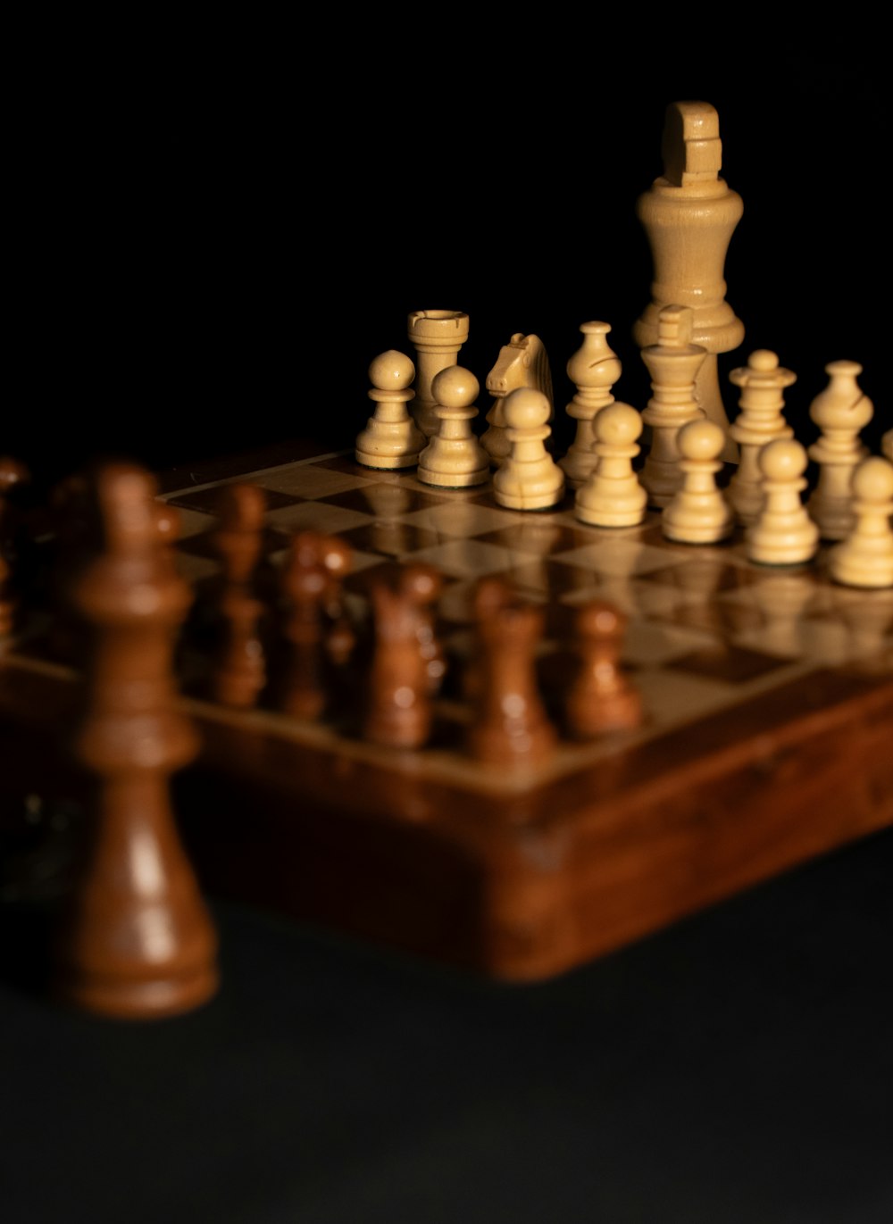 a wooden chess board with pieces on it