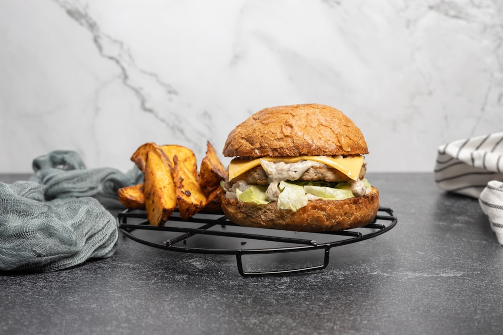 a burger with a side of fries on a cooling rack