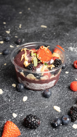 a bowl of fruit and nuts on a table