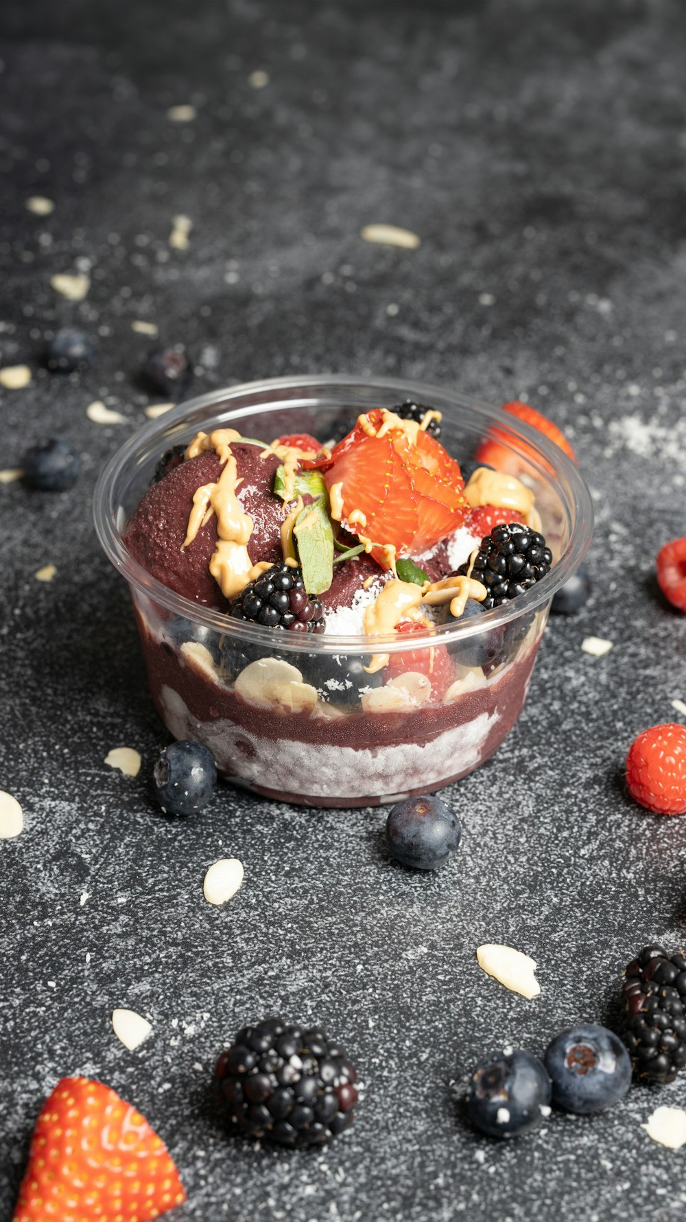 a bowl of fruit and nuts on a table