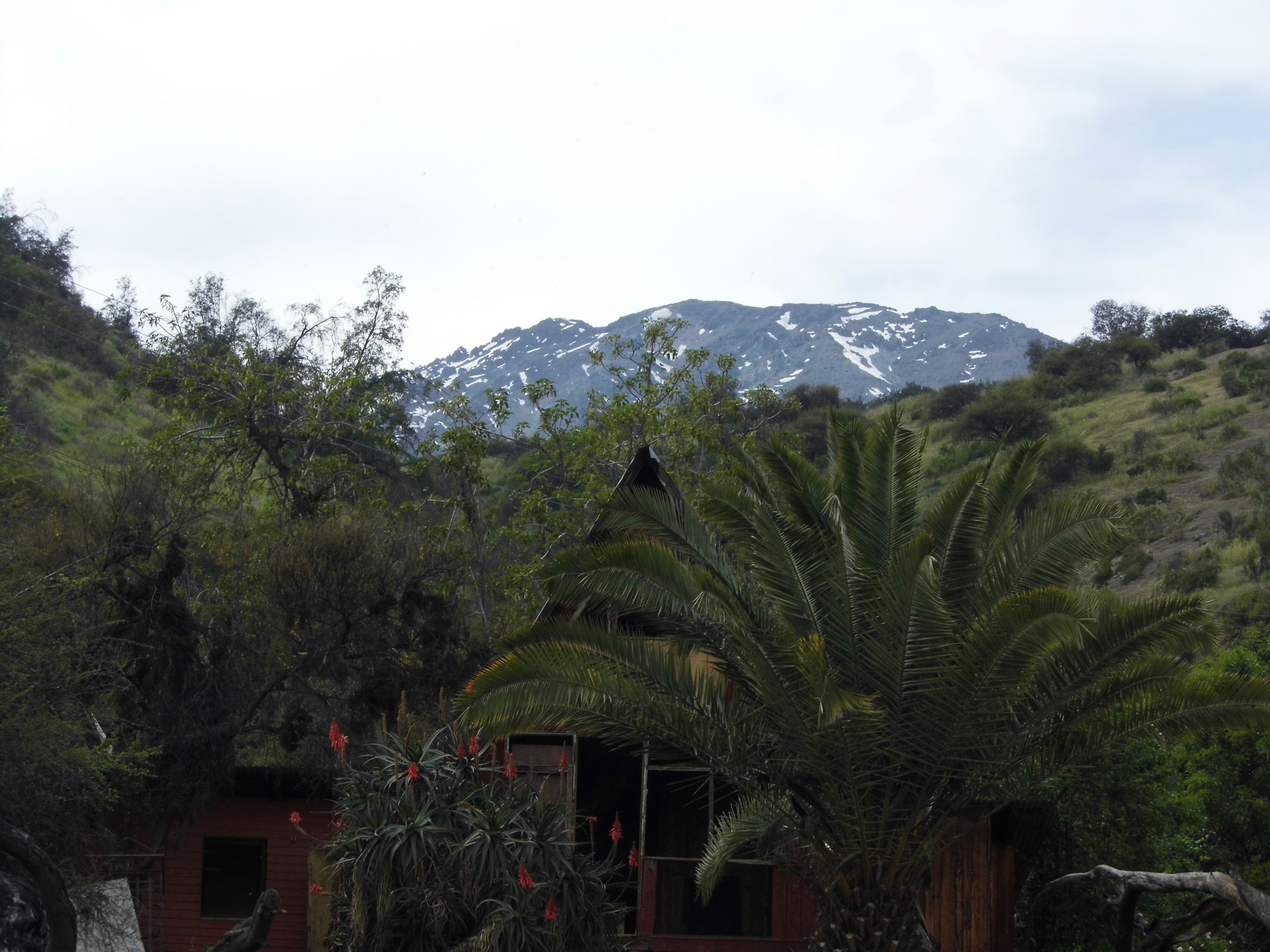 a house with a mountain in the background