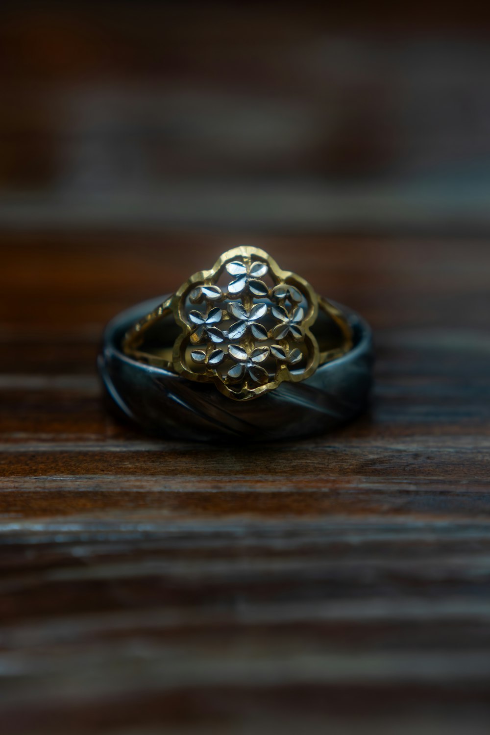 a close up of a ring on a wooden surface