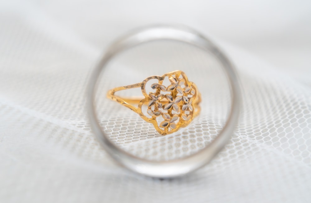 a close up of a ring on a white cloth