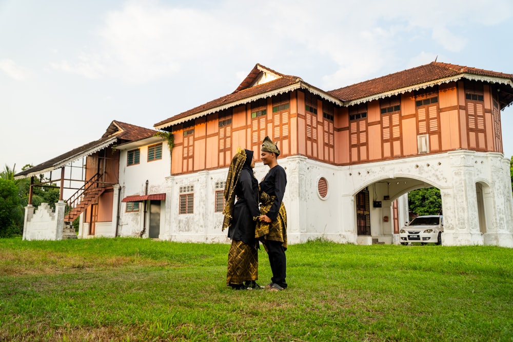 a couple of people standing in front of a building