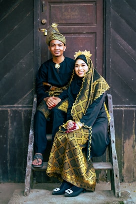 a man and a woman sitting on a step ladder