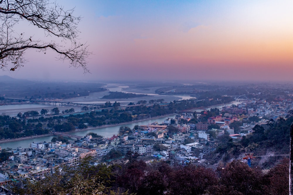 a view of a city and a river from a hill