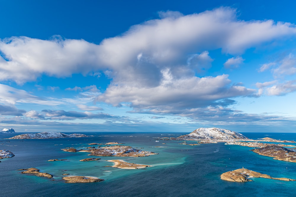 a large body of water surrounded by snow covered mountains