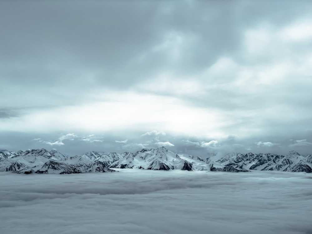 a view of a mountain range covered in clouds