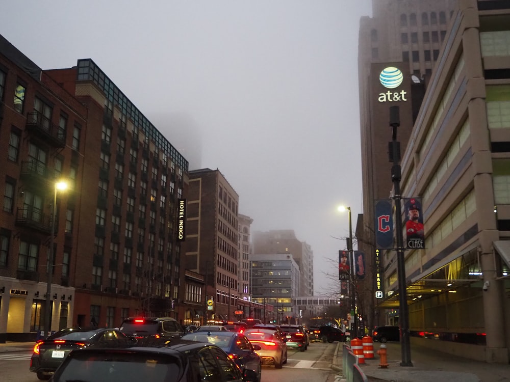 a city street filled with lots of traffic next to tall buildings