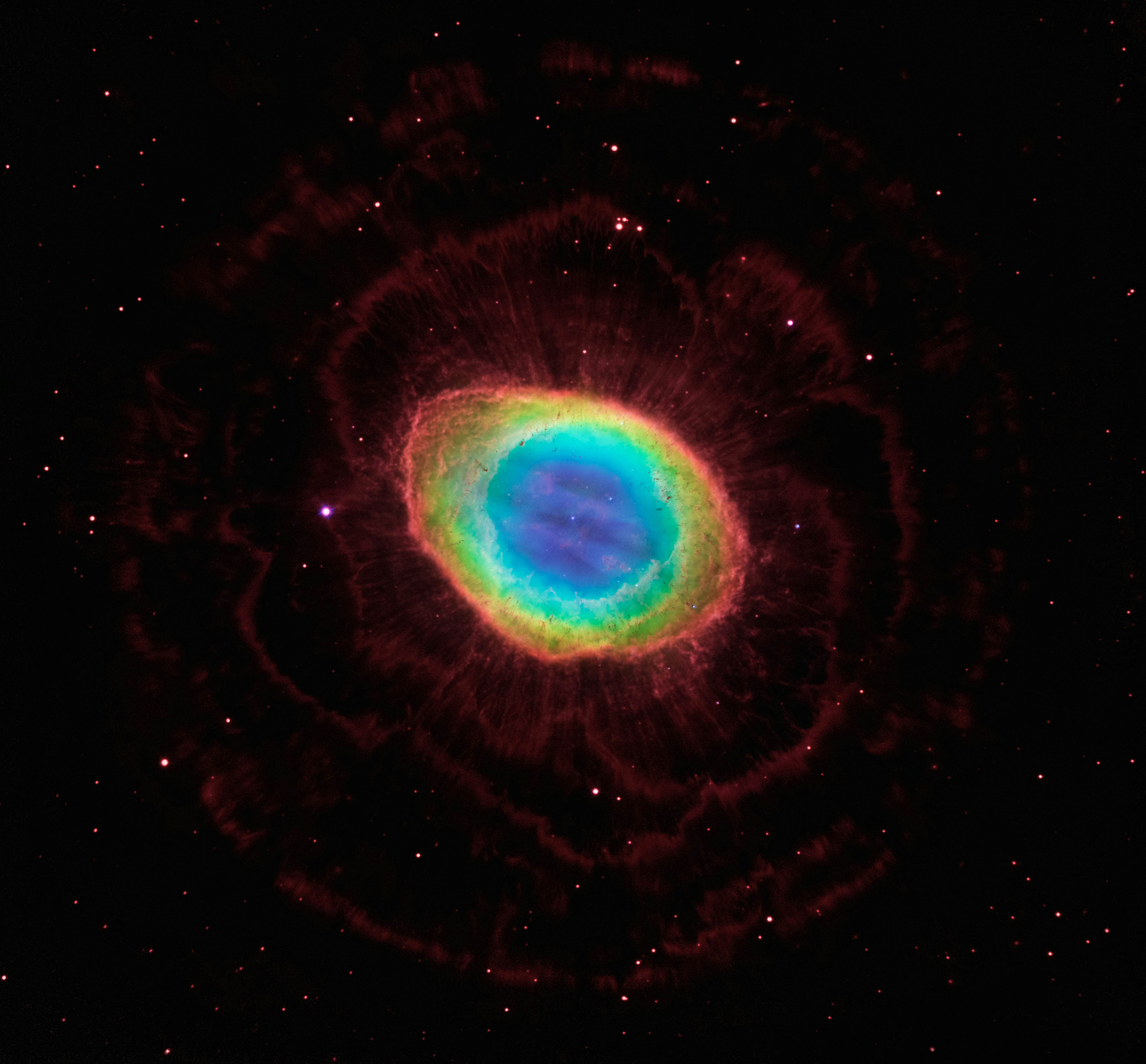 a blue and green ring in the middle of a black sky